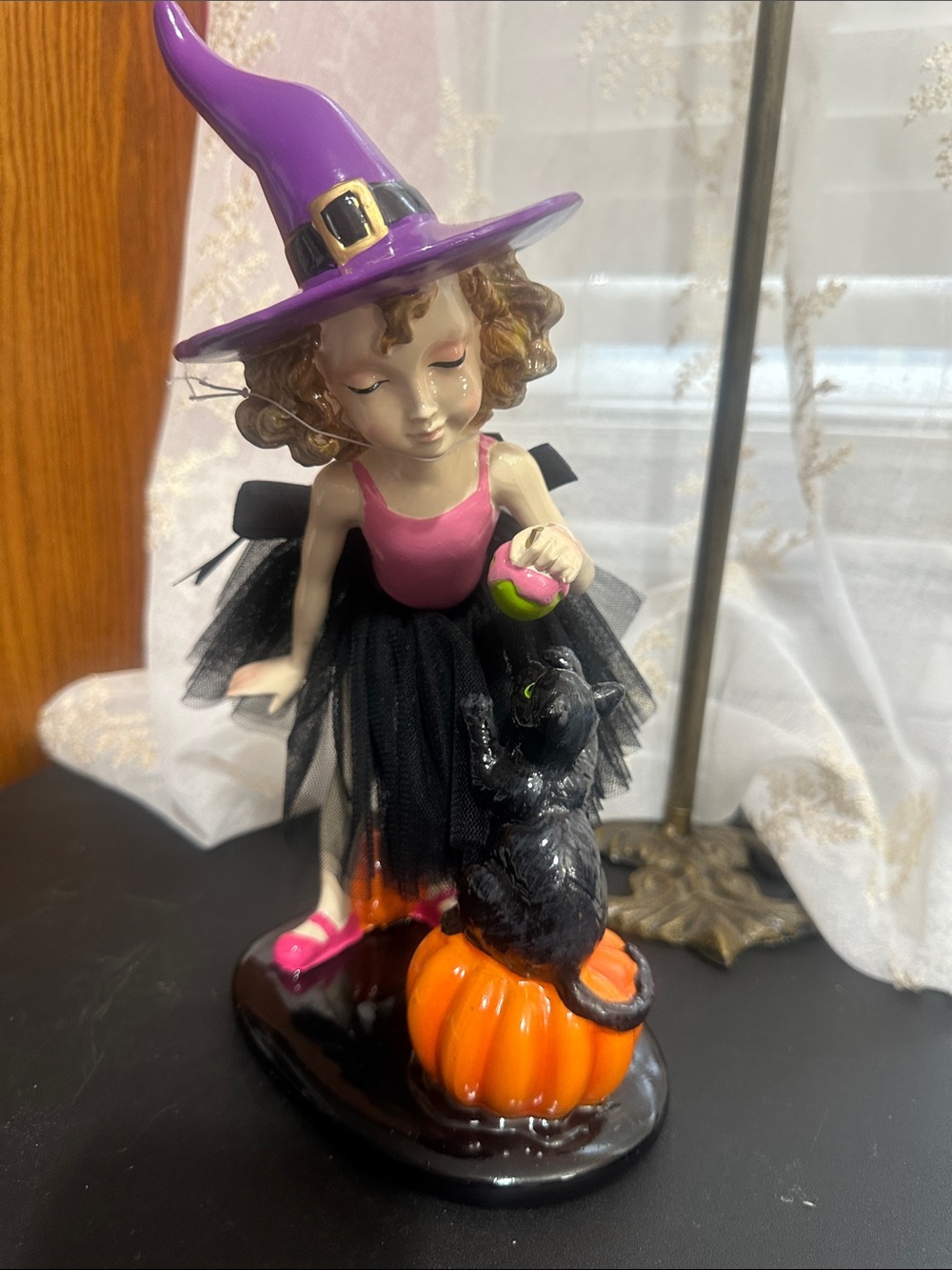 Ghoulish Halloween little girl with black cat decor